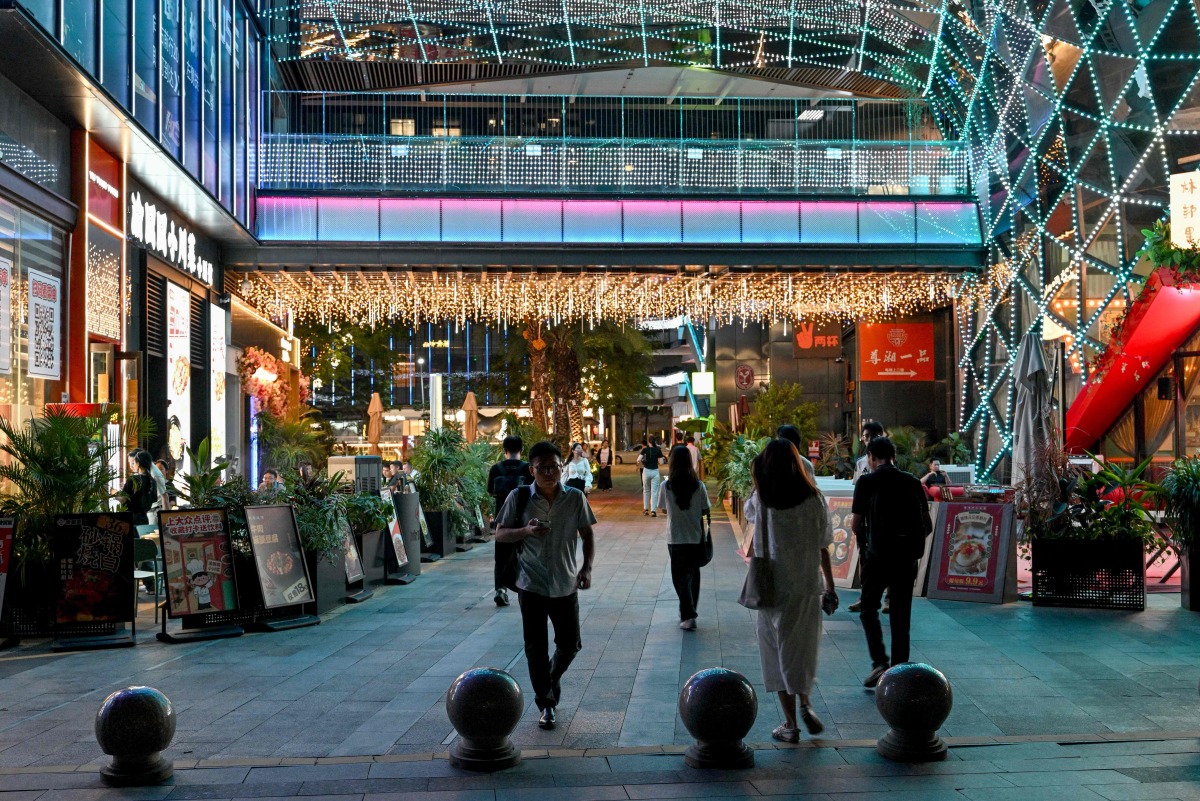 People visit a shopping centre in Shenzhen, China's southern Guangdong province on July 17, 2025. (Photo by ADEK BERRY / AFP)