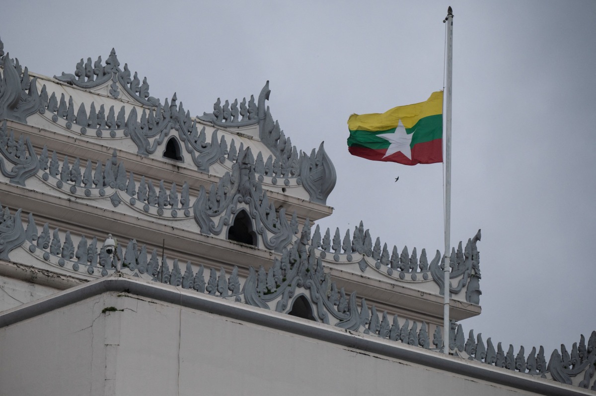 Myanmar's national flag flutters at half-mast outside the City Hall in Yangon on July 19, 2025, on the 78th Martyrs' Day that marks the anniversary of the assassination of independence leaders, including general Aung San, father of the currently deposed and imprisoned leader Aung San Suu Kyi. (Photo by AFP)


