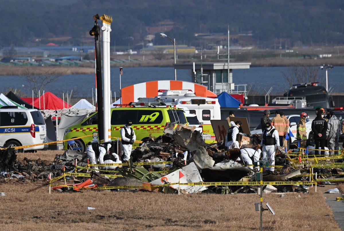 Recovery teams work at the scene where a Jeju Air Boeing 737-800 series aircraft crashed and burst into flames at Muan International Airport in Muan, some 288 kilometres southwest of Seoul on December 30, 2024. Photo by JUNG YEON-JE / AFP