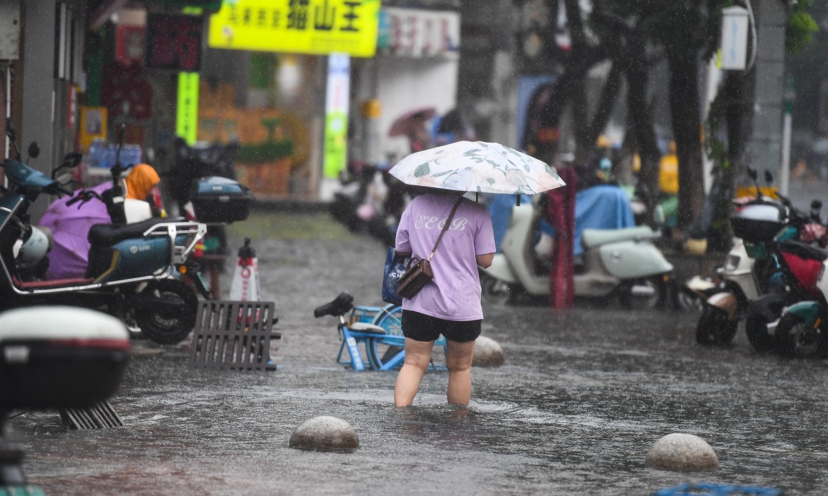 A pedestrian wades through a flooded area in Haikou, south China's Hainan Province, July 20, 2025. Typhoon Wipha, the sixth typhoon of the year, made landfall near Jiangmen City in south China's Guangdong Province around 5:50 p.m. on Sunday. (Xinhua/Yang Guanyu)
