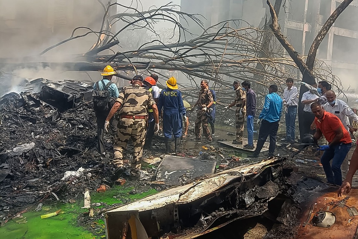 This handout taken and posted on the X (formerly Twitter) account of the Central Industrial Security Force (CISF) On June 12, 2025 shows rescue officials working at the site where Air India flight 171 crashed in a residential area near the airport in Ahmedabad. (Photo by Handout / CENTRAL INDUSTRIAL SECURITY FORCE (CISF) / AFP)