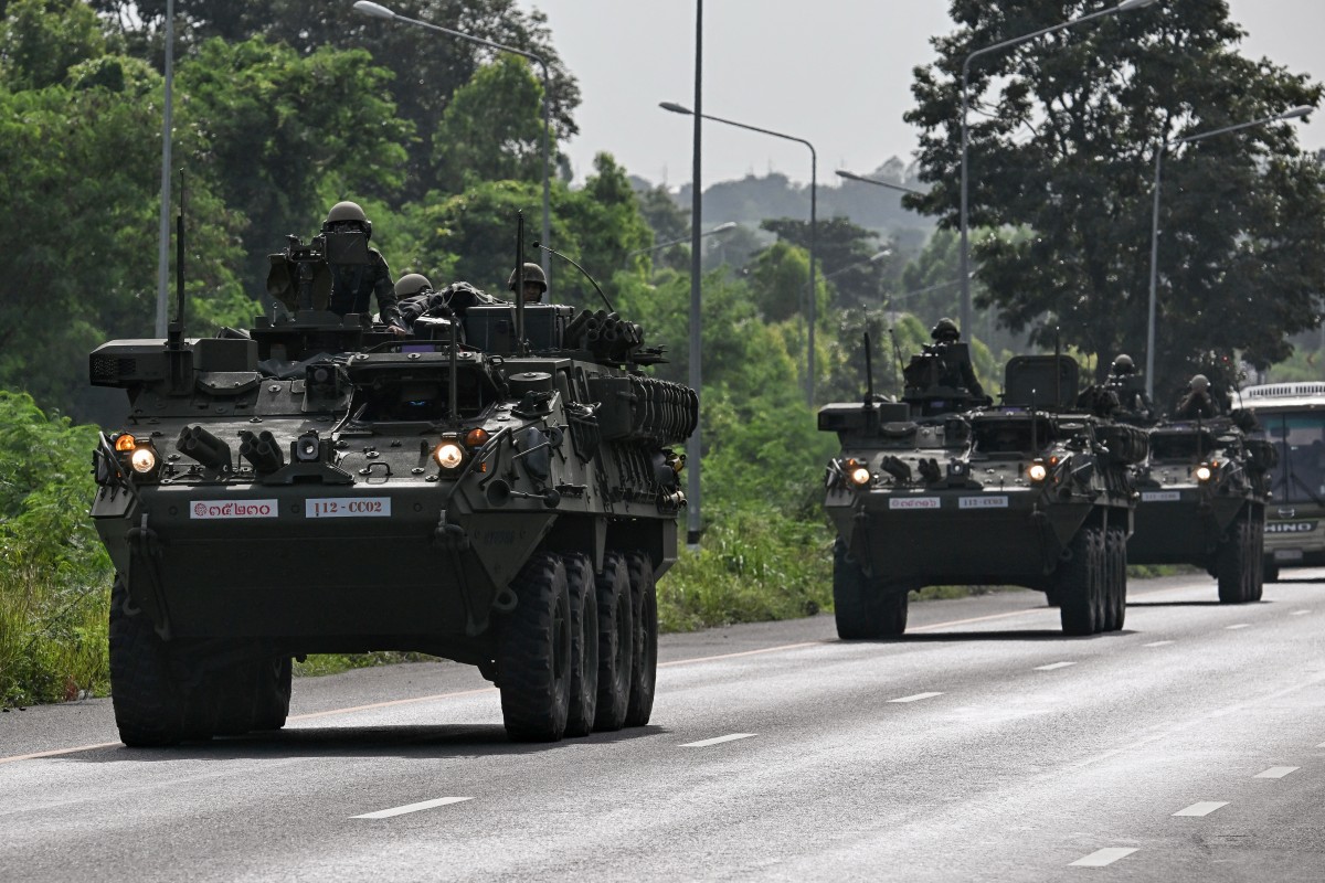 Royal Thai Army soldiers are pictured on armoured vehicles on a road in Chachoengsao province on July 24, 2025. Photo by Lillian SUWANRUMPHA / AFP.