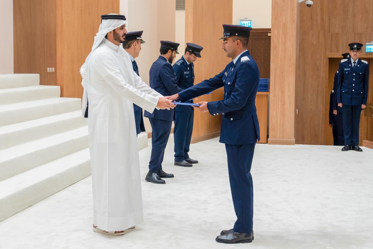 Minister of Interior and Commander of the Internal Security Force (Lekhwiya) - Chairman of the Supreme Council of the Police Academy H E Sheikh Khalifa bin Hamad bin Khalifa Al-Thani presenting certificate to a graduate during the ceremony.