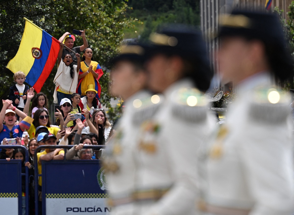 People cheer during the military parade to commemorate Colombia's Independence Day in Bogota on July 20, 2025. (Photo by Luis ACOSTA / AFP)
