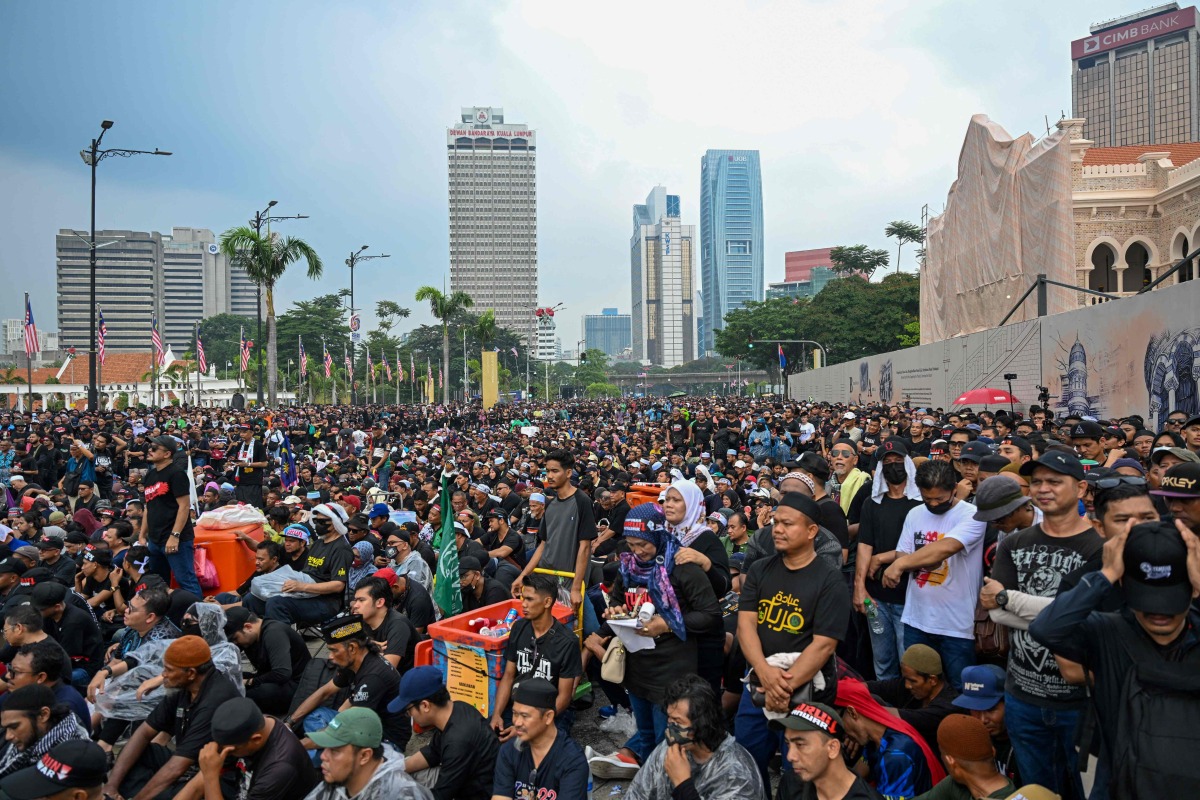 Protesters gather near Merdeka Square during a protest in Kuala Lumpur on July 26, 2025. (Photo by Mohd RASFAN / AFP)