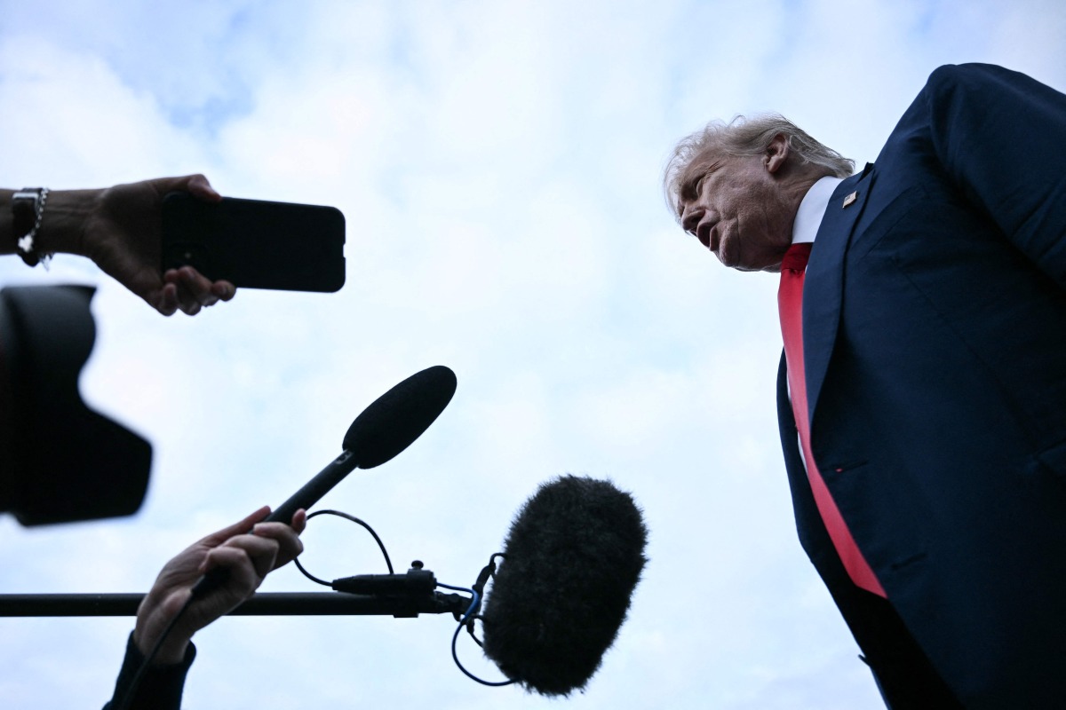 US President Donald Trump speaks to the press after disembarking from Air Force One upon his arrival at Prestwick Airport, south of Glasgow on July 25, 2025, on the first day of his UK visit. (Photo by Brendan SMIALOWSKI / AFP)
