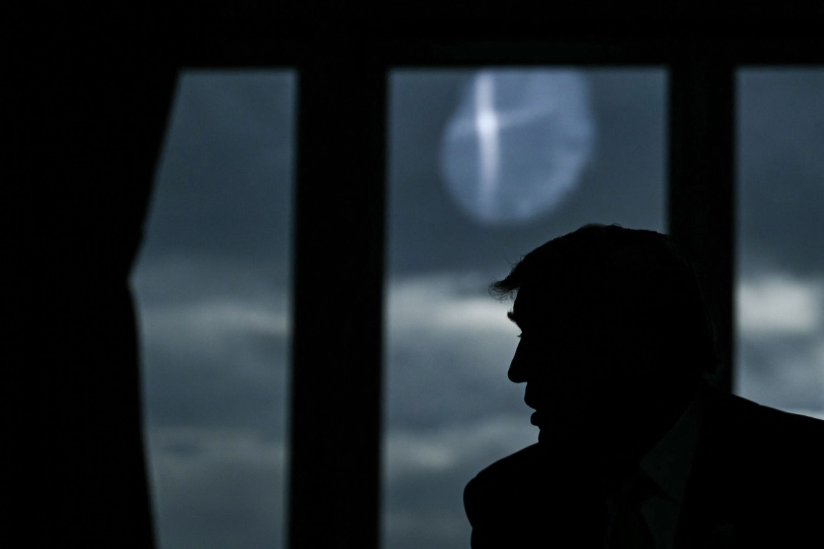 The profile of US President Donald Trump is pictured in backlight as he speaks with European Commission President Ursula von der Leyen (2nd R) during a meeting, in Turnberry south west Scotland, on July 27, 2025, on the third day of his visit to the country, since his second tenure as President began. Photo by Brendan SMIALOWSKI / AFP