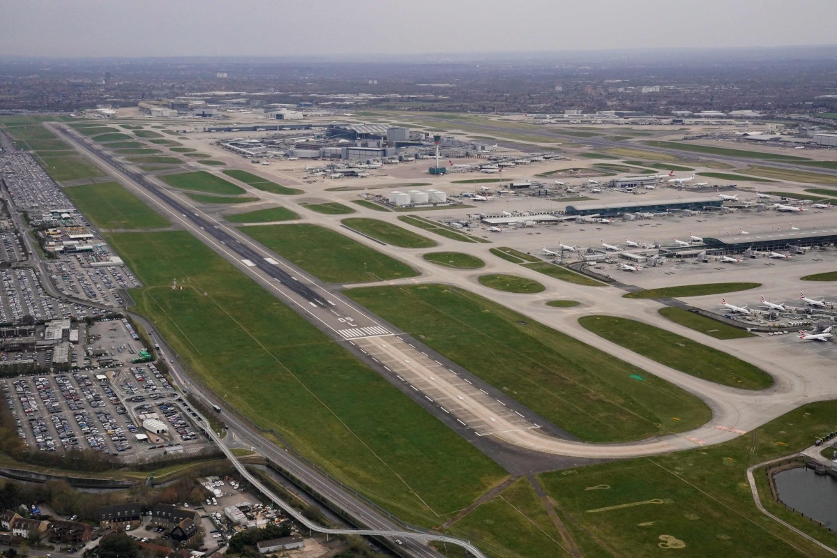 An aerial photograph taken on March 21, 2025 shows planes parked on the tarmac of Heathrow Airport following its closure after a fire broke out at a substation supplying power of the airport, in Hayes, west London. Photo by AFP