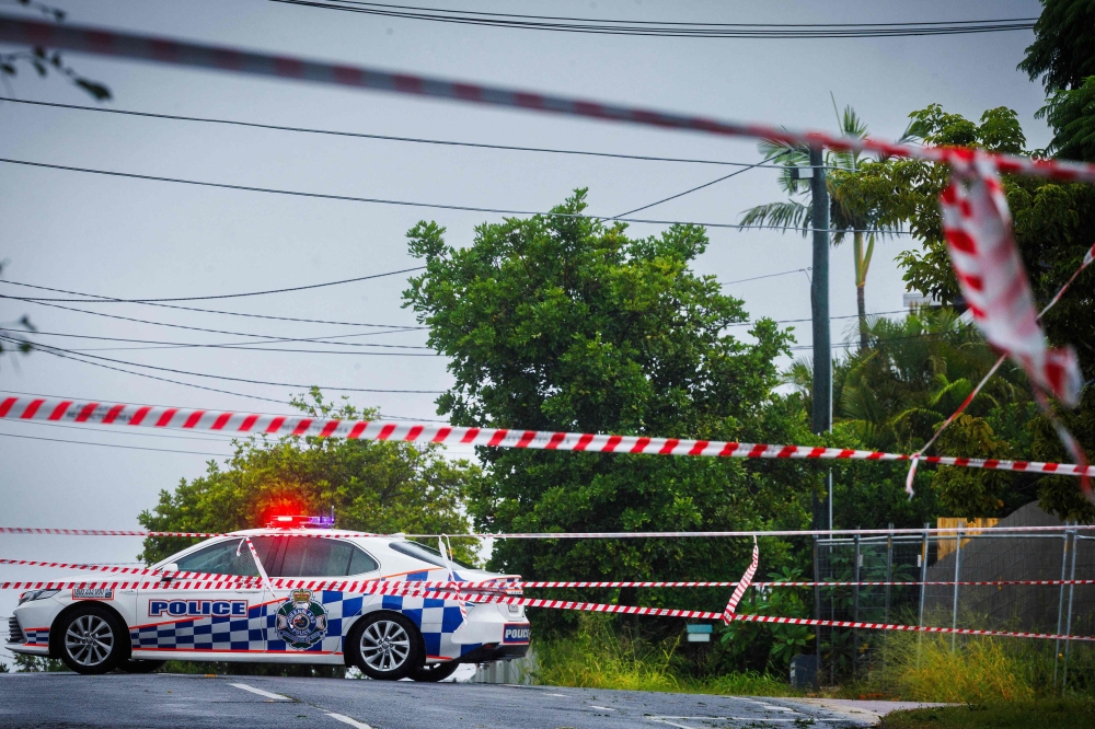 File photo for representational purposes. Police cordons are displayed to stop traffic after power lines fell across a road in Coorparoo in Brisbane on March 8, 2025, as cyclone Alfred crossed the southeast Queensland coast. (Photo by Patrick Hamilton / AFP)