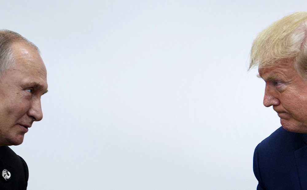 (Files) US President Donald Trump (R) attends a meeting with Russia's President Vladimir Putin during the G20 summit in Osaka on June 28, 2019. (Photo by Brendan Smialowski / AFP)
