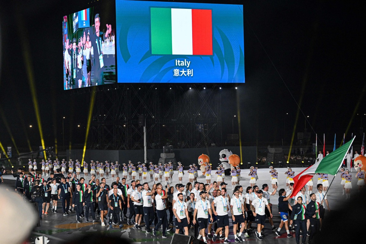 Members of Italy's delegation wave their country's national flag as they take part in the athletes' parade during the opening ceremony of the 2025 World Games at the Tianfu International Convention Centre in Chengdu, in China's southwestern Sichuan province on August 7, 2025. Photo by JADE GAO / AFP
