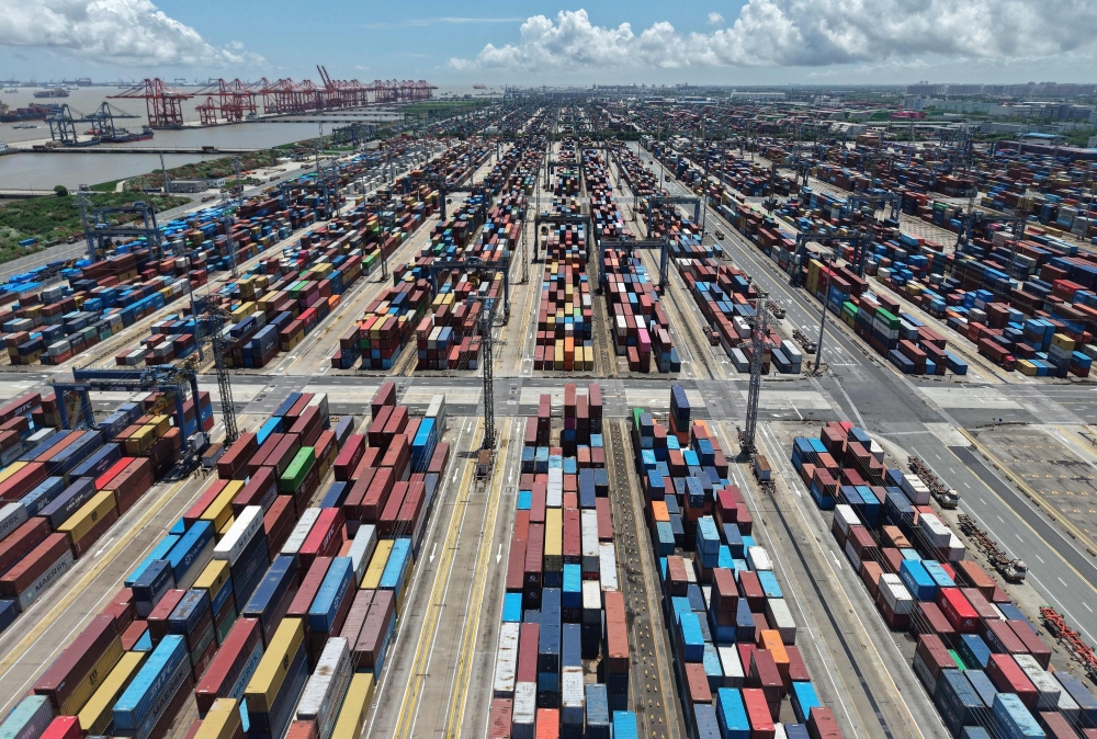 Containers are seen at the port in Shanghai on August 12, 2025. (Photo by AFP) 