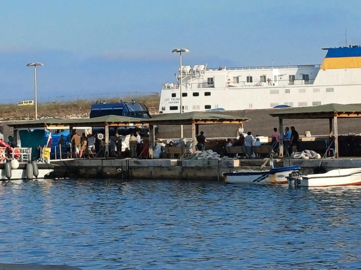 Migrants disembark from the boat that rescued them after their ship sank off the coast of Italy's Lampedusa island in the harbour of Italian island of Lampedusa on August 14, 2025. Photo by -STR / ANSA / AFP