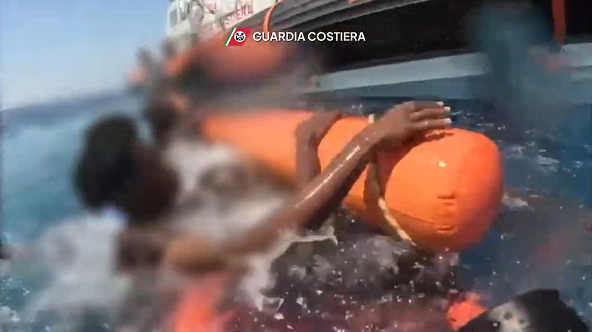 This handout video grab taken and released by the Italian Guardia Costiera on August 14, 2025, shows migrants being rescued at sea by the Guardia Costiera after their boat sank at sea off the island of Lampedusa. (Photo by GUARDIA COSTIERA / AFP)