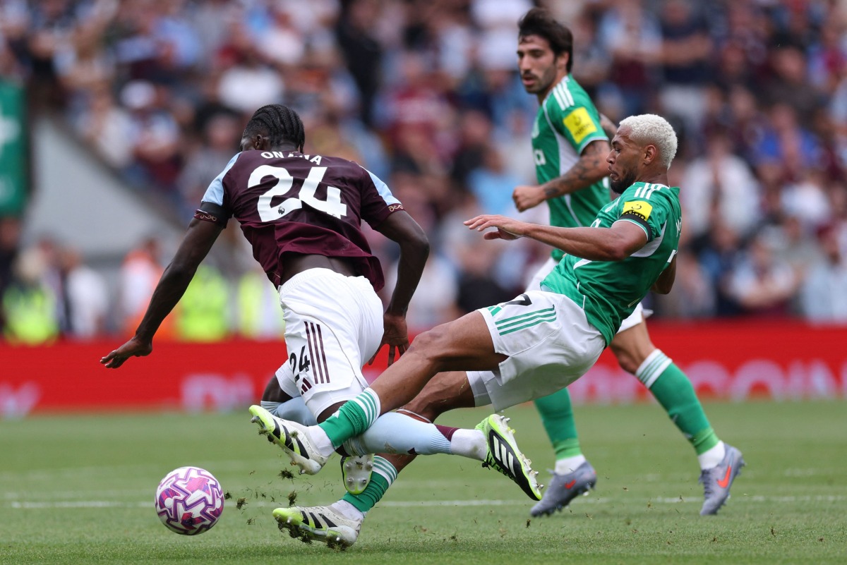 Newcastle United's Brazilian midfielder #07 Joelinton (R) fouls Aston Villa's Belgian defender #24 Amadou Onana (L) during the English Premier League football match between Aston Villa and Newcastle United at Villa Park in Birmingham, central England on August 16, 2025. (Photo by Adrian Dennis / AFP) 