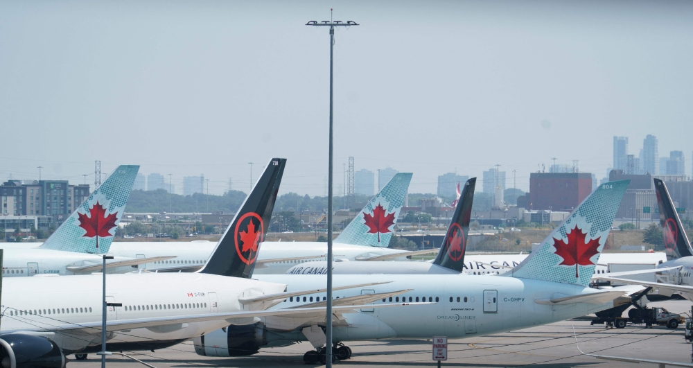 Air Canada airplanes stand on the tarmac at Pearson International Airport in Toronto on August 16, 2025. (Photo by Peter Power / AFP)