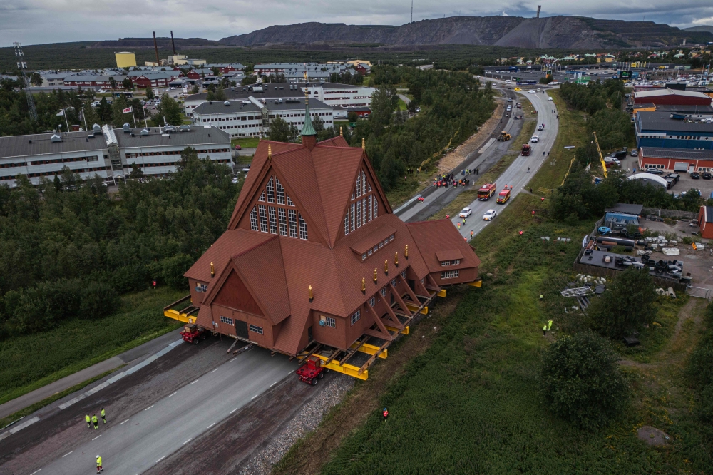 The wooden Kiruna Church is transferred to its new location, in Kiruna, Sweden on August 20, 2025. (Photo by Jonathan Nackstrand / AFP)