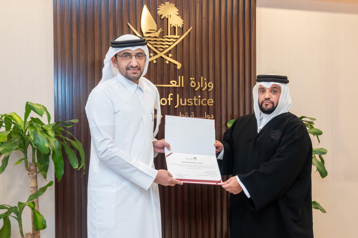 Minister of Justice and Minister of State for Cabinet Affairs H E Ibrahim bin Ali Al Mohannadi with a new lawyer during the oath-taking ceremony. 