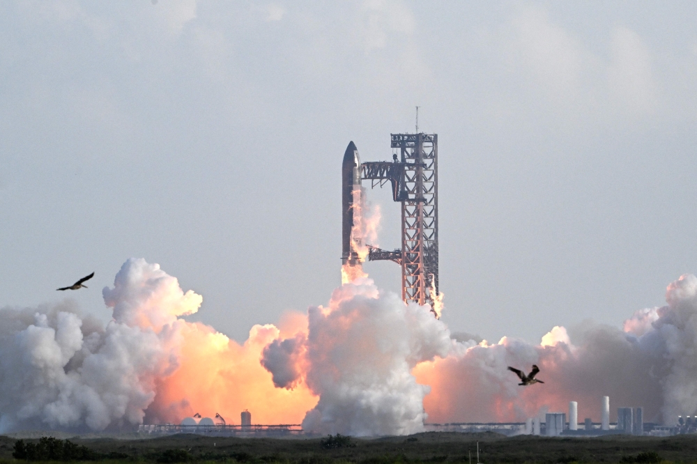 SpaceX's Starship rocket lifts off from Starbase, Texas, as seen from South Padre Island on August 26, 2025, for its tenth test flight. (Photo by Ronaldo Schemidt / AFP)