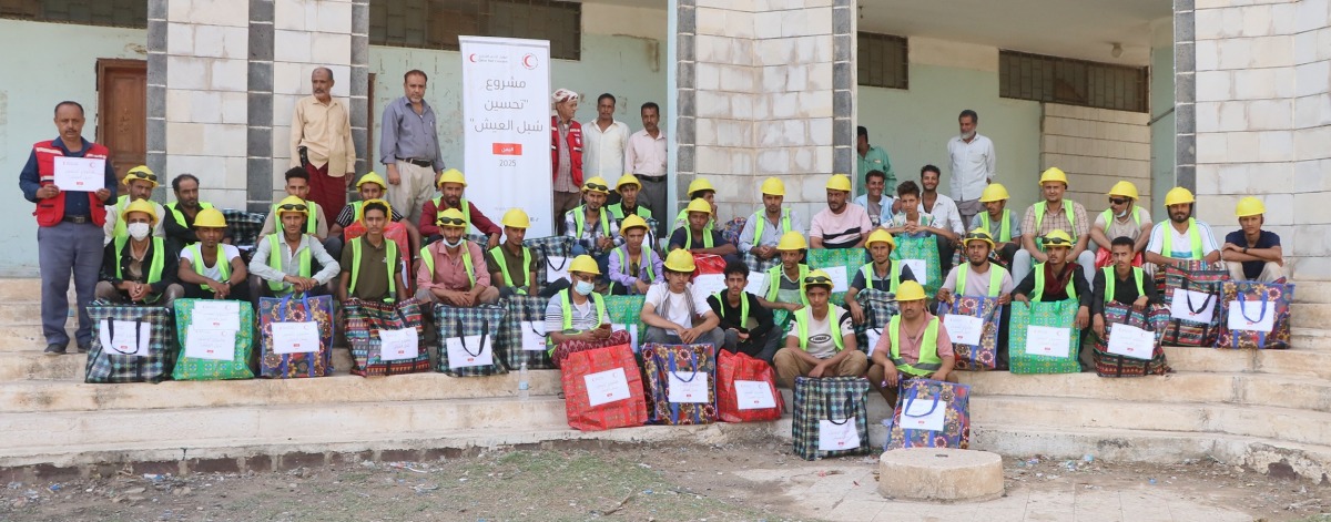 A group of the project's beneficiaries with carpentry toolkits.