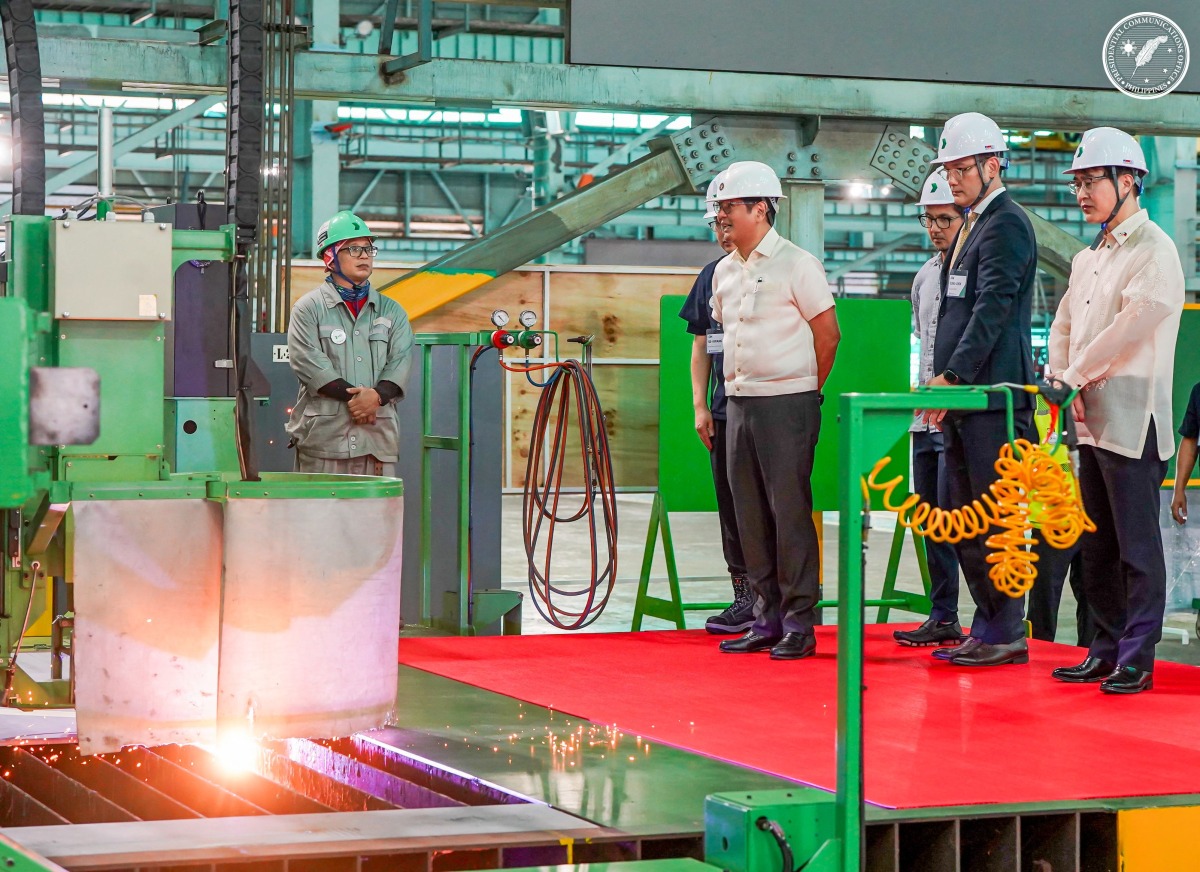 This handout photo taken and released by the Philippines' Presidential Communications Office (PCO) on September 2, 2025 shows Philippines' President Ferdinand Marcos Jr. (2nd L) inspecting the production during the inauguration of the Hyundai Shipyard in the province of Zambales. Photo by Handout / Presidential Communications Office (PCO) / AFP
