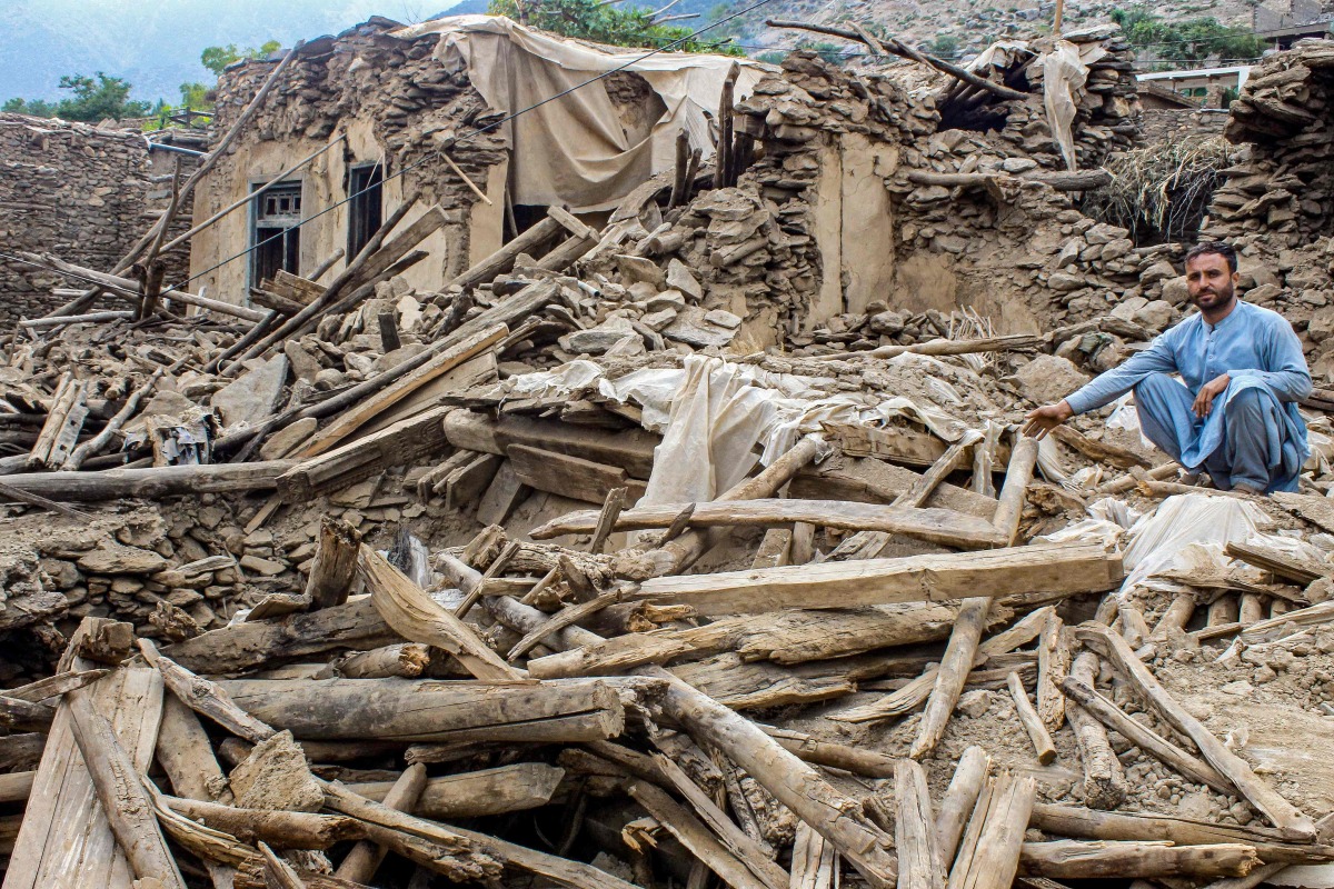 An Afghan man sits amid the remains of a damaged house, in the aftermath of an earthquake at the Dara-i-Nur district of Nangarhar province on September 3, 2025. Photo by AFP