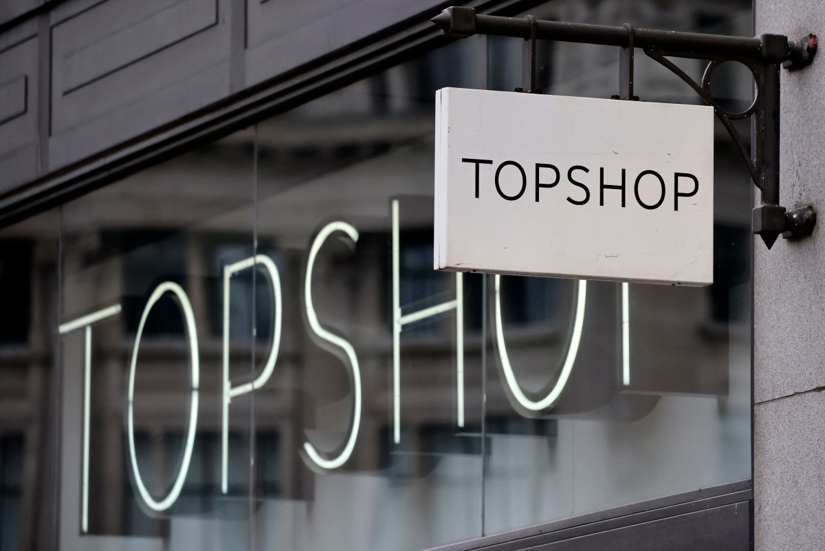 A sign is pictured outside a closed branch of the fashion retailer Topshop in central London on February 1, 2021. Photo by Tolga Akmen / AFP