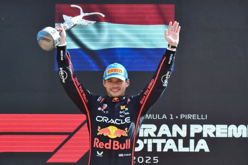 Red Bull Racing's Dutch driver Max Verstappen celebrates his victory on the podium after winning the Italian Formula One Grand Prix at the Autodromo Nazionale Monza circuit, in Monza, northern Italy, on September 7, 2025. (Photo by Marco Bertorello / AFP)