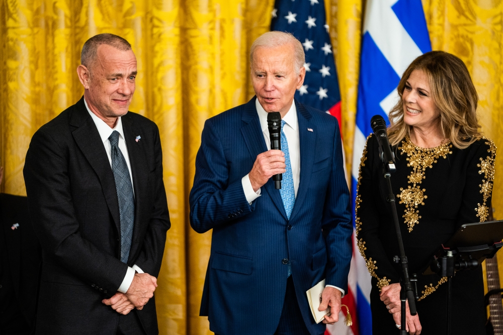 File photo: US President Joe Biden, with actor Tom Hanks and his wife, the actress and musician Rita Wilson, at the White House in 2023. (Photo by Demetrius Freeman/The Washington Post)