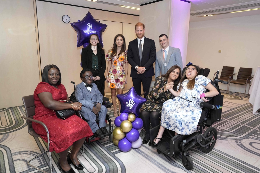Britain's Prince Harry, Duke of Sussex, poses with previous WellChild award recipients (back L-R) Em Subinger, Evie Toombes and Dylan Bleach, and Ruky Anighoro (2L) with his mother Ufuoma, and Rhea Talwar (R) with her mother Purabi at the annual WellChild Awards in London on September 8, 2025. (Photo by Aaron Chown / POOL / AFP)