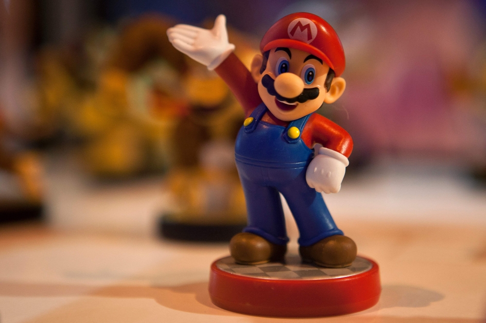 (Files) This file photo taken on October 2, 2015 shows a figurine representing Japanese multinational Nintendo's famous video game character Mario Bros on display during the Madrid Games Week 2015 in Madrid. (Photo by Sebastien Berda / AFP) 
