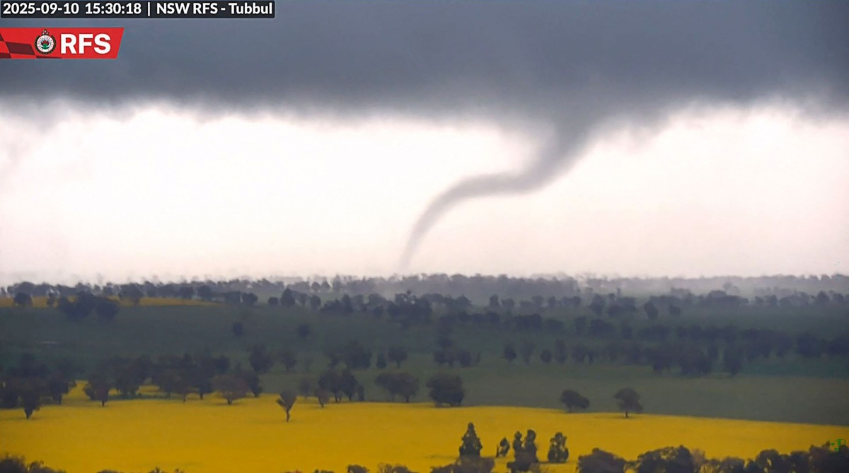 This screengrab from handout surveillance camera footage taken and released by New South Wales Rural Fire Service (NSW RFS) on September 10, 2025 shows a tornado over the countryside near Young in New South Wales. (Photo by Handout / NSW Rural Fire Service (NSW RFS) / AFP) 