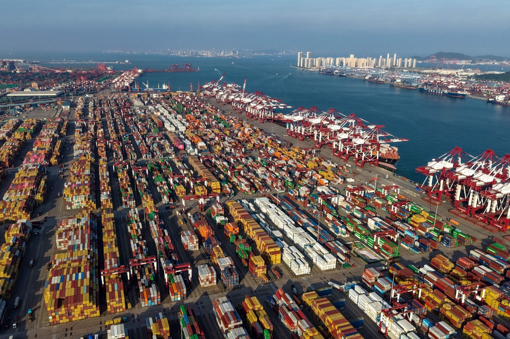 Containers and ships are seen at the container terminal of the port in Qingdao, in China's eastern Shandong province on September 10, 2025. (Photo by AFP)
 