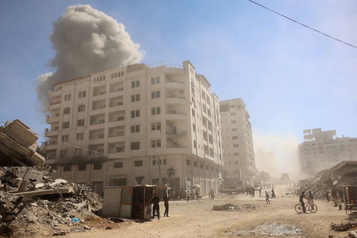 Smoke billows after an Israeli strike on a building in Gaza City's Tal al-Hawa district on September 13, 2025. (Photo by Omar AL-QATTAA / AFP)
