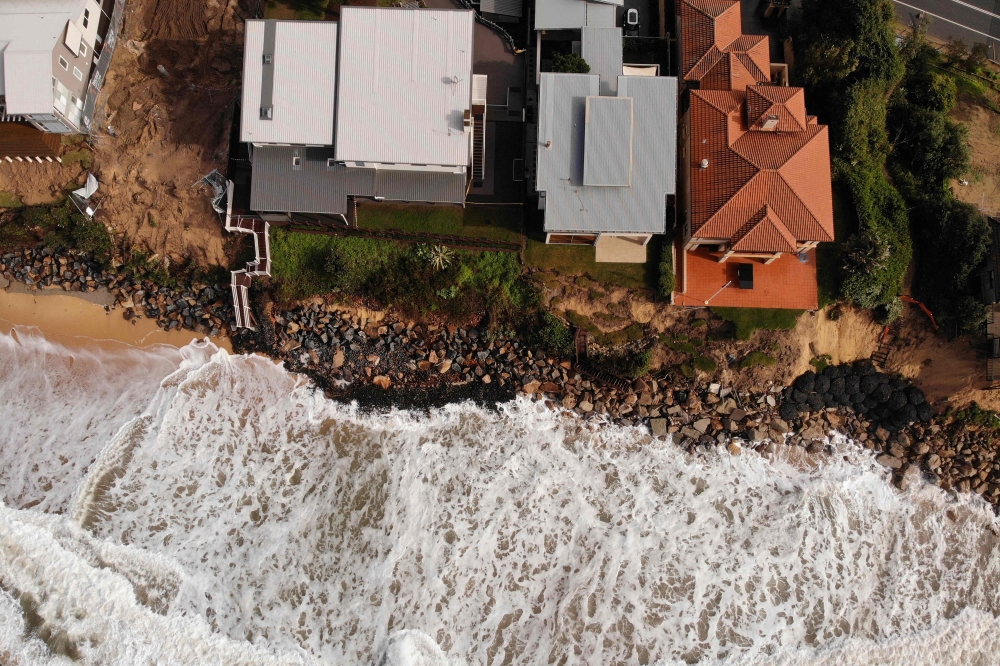 (Files) An aerial file photo taken on July 28, 2020 shows homes perched on Australia's eastern coastal town of Wamberal. (Photo by Peter Parks / AFP)