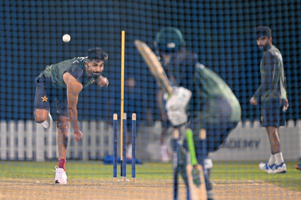 Pakistan's Haris Rauf bowls during a practice session at the International Cricket Council (ICC) Academy in Dubai on September 16, 2025, ahead of their Asia Cup 2025 Twenty20 international cricket match against the UAE. (Photo by Sajjad Hussain / AFP)
