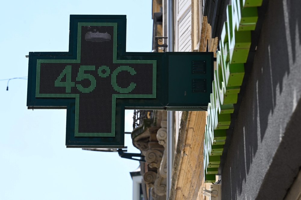 (Files) A pharmacy sign displays a temperature of 45 degrees Celsius in Thionville, north-eastern France, on July 2, 2025, as a heatwave hits Europe. (Photo by Jean-Christophe Verhaegen / AFP)
