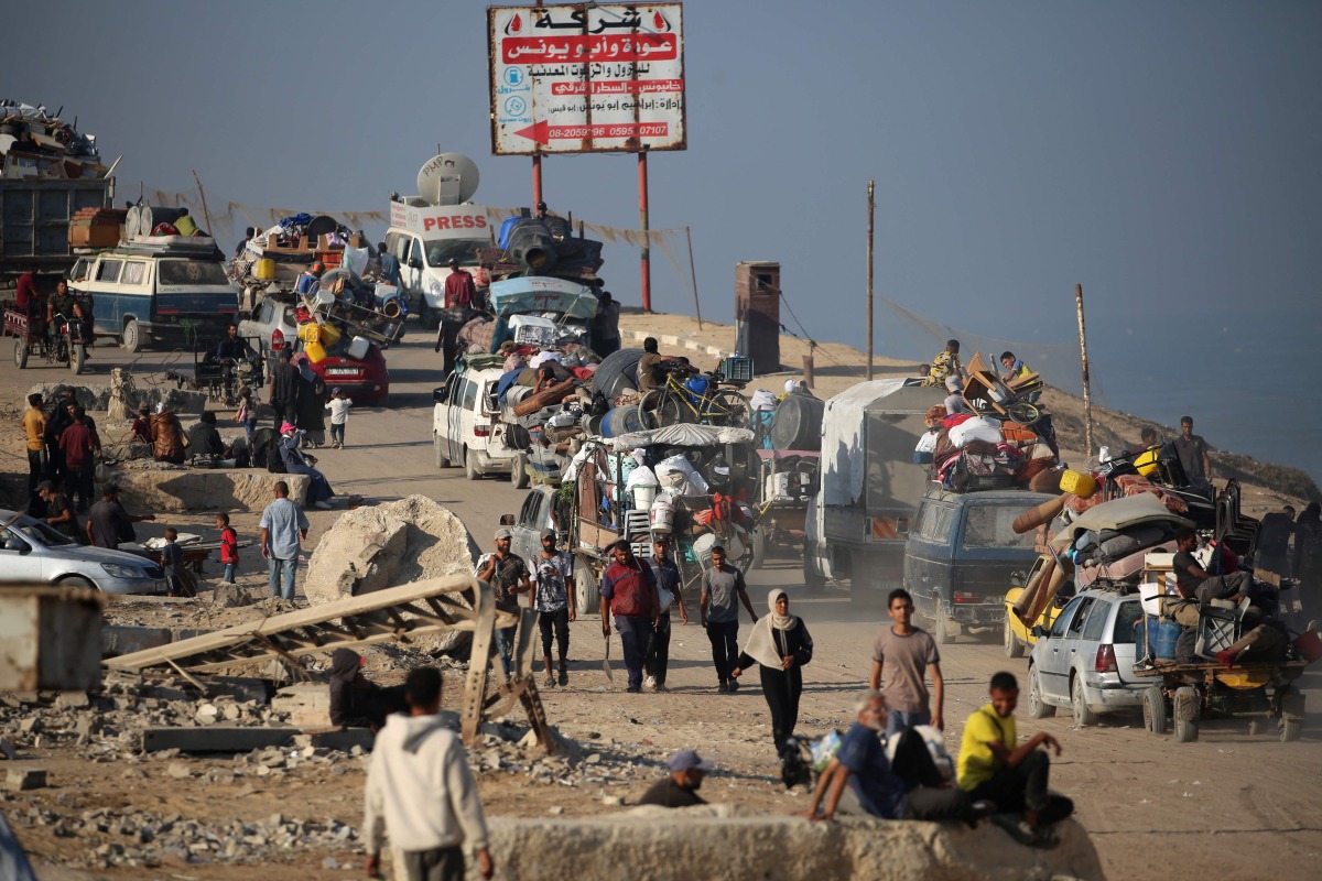Displaced Palestinians move with their belongings southwards on a road in the Nuseirat refugee camp area in the central Gaza Strip following renewed Israeli evacuation orders for Gaza City on September 18, 2025. Photo by Eyad BABA / AFP