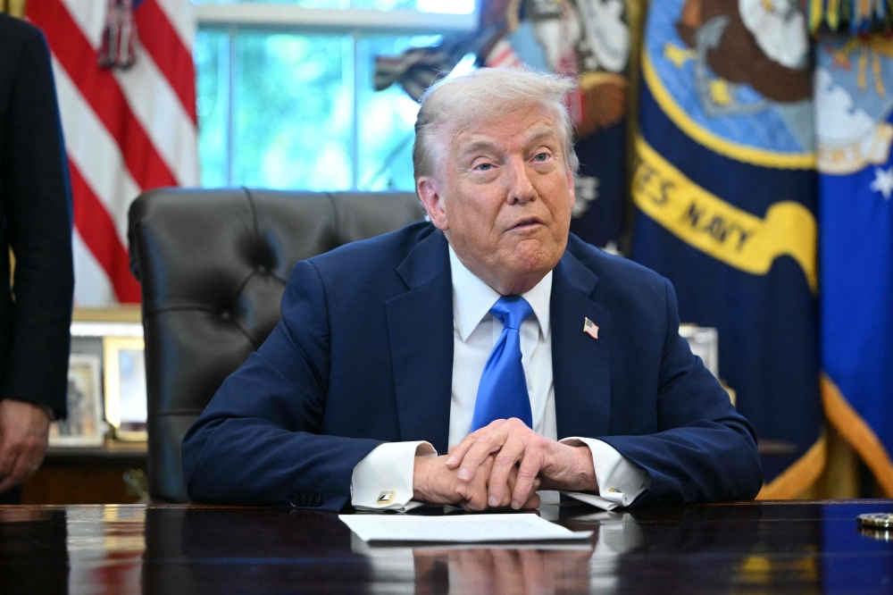 US President Donald Trump speaks before signing executive orders in the Oval Office at the White House in Washington, DC, on September 19, 2025. (Photo by Mandel Ngan/ AFP)