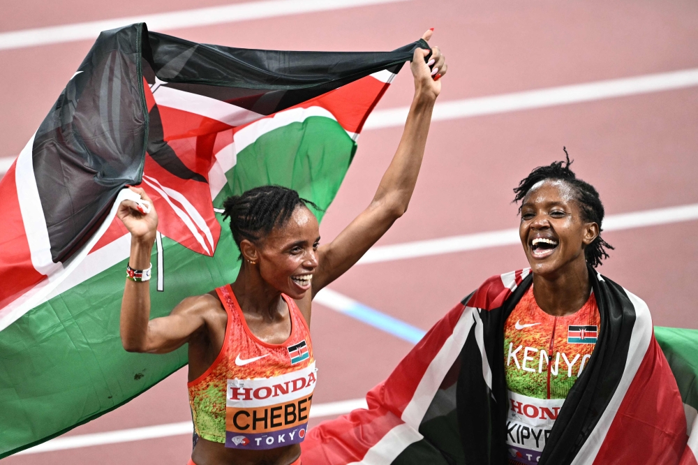 Kenya's Beatrice Chebet and Kenya's athlete Faith Kipyegon (R) celebrate after the women's 5000m final during the World Athletics Championships in Tokyo on September 20, 2025. (Photo by Philip Fong / AFP)