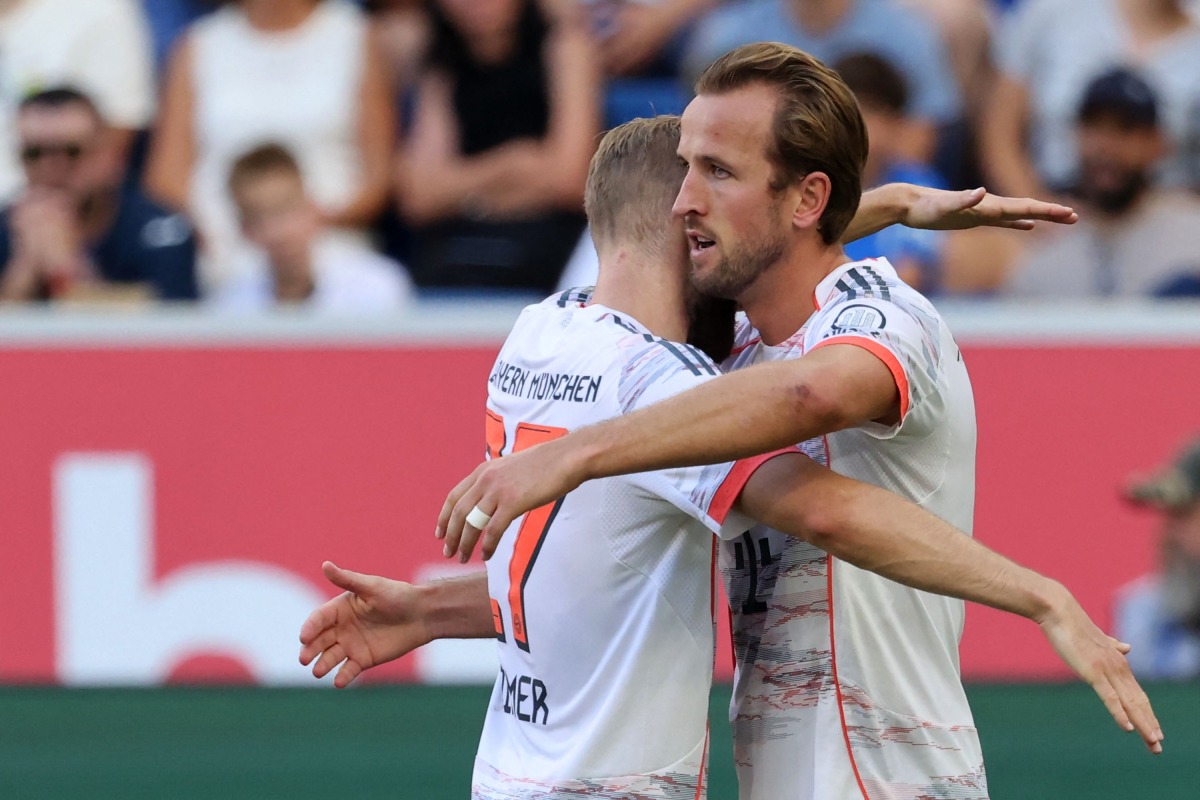 Bayern Munich's English forward #09 Harry Kane (R) celebrates with team mate Bayern Munich's Austrian midfielder #27 Konrad Laimer after scoring his team's third goal during the German first division Bundesliga football match between TSG 1899 Hoffenheim and FC Bayern Munich in Sinsheim, southwestern Germany on September 20, 2025. (Photo by Daniel ROLAND / AFP)