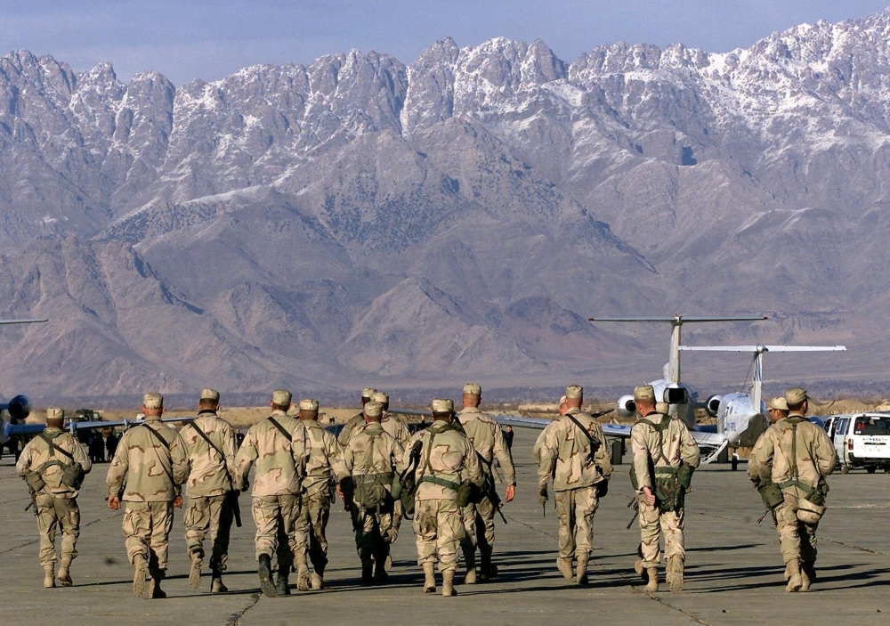 (Files) In this file photo taken on January 15, 2002, American soldiers approach the United Nations planes on the tarmac of the Bagram airbase in Bagram. (Photo by Jimin Lai / AFP)