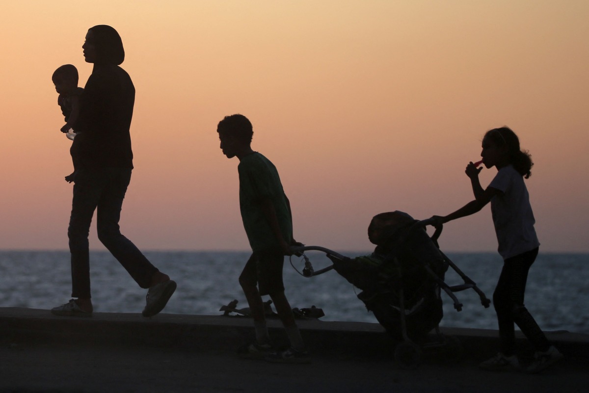 Displaced Palestinians move with their belongings southwards on a road in the Nuseirat refugee camp area in the central Gaza Strip on September 20, 2025, as Israel presses its ground offensive to capture Gaza City. Photo by Eyad BABA / AFP