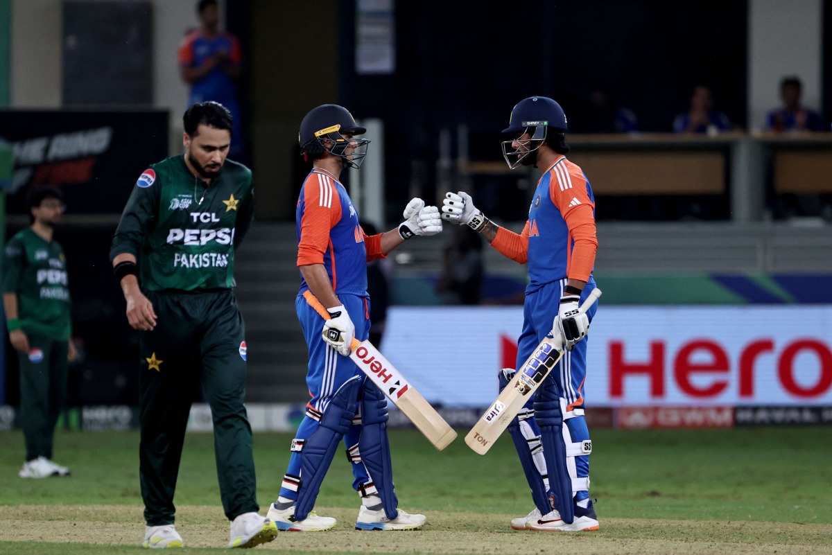 India's Abhishek Sharma and Tilak Varma bump fists during the Asia Cup 2025 Super Four Twenty20 international cricket match between India and Pakistan at the Dubai International Stadium in Dubai on September 21, 2025. (Photo by Fadel SENNA / AFP)
