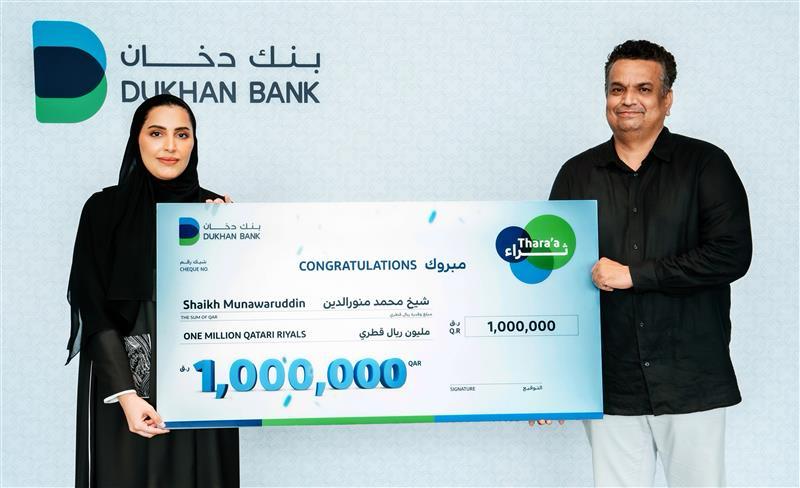 Dukhan Bank official with Thara'a grand prize winner.