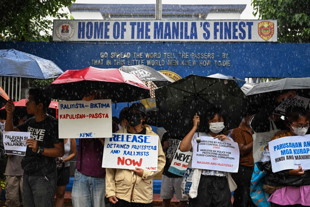 Youth groups stage a protest in front of the Manila Police District Headquarters to demand the release of arrested individuals a day after an anti-corruption rally in Manila on September 22, 2025. (Photo by Jam Sta Rosa / AFP)
 