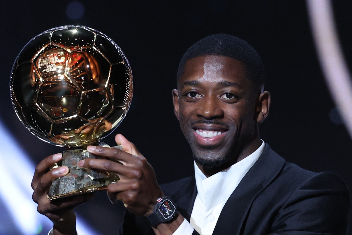 Paris Saint-Germain's French forward Ousmane Dembele reacts receiving the Ballon d'Or award during the 2025 Ballon d'Or France Football award ceremony at the Theatre du Chatelet in Paris on September 22, 2025. (Photo by Franck FIFE / AFP)
