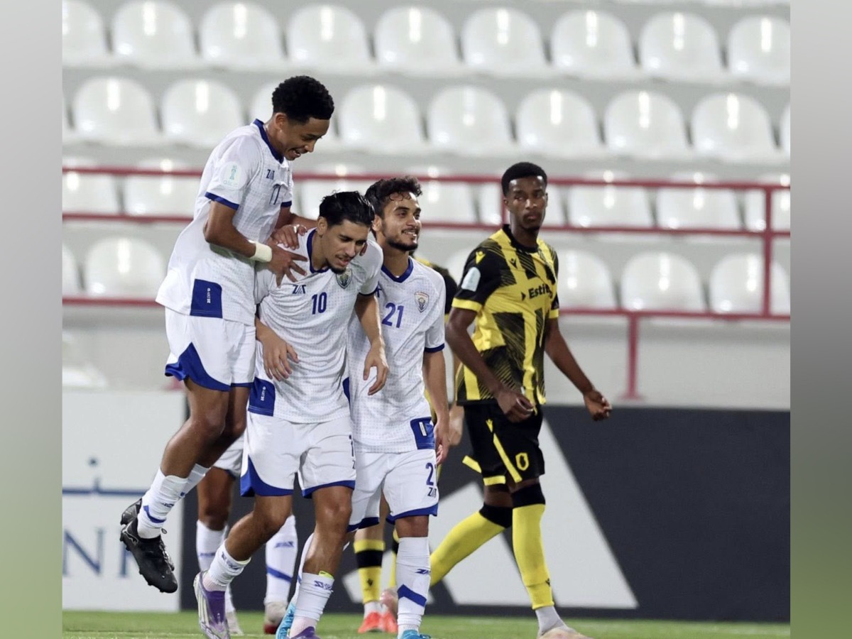 Al Kharaitiyat players celebrate after scoring a goal.