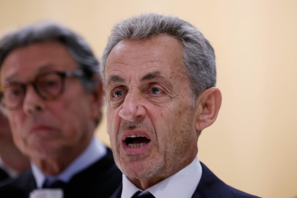 Former French president Nicolas Sarkozy reacts after the verdict in his trial for illegal campaign financing from Libya for his successful 2007 presidential bid, at the Tribunal de Paris courthouse in Paris, on September 25, 2025. (Photo by Alain Jocard / AFP)
