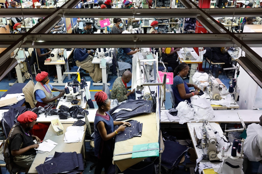 Workers operate sewing machines to stitch pieces of fabric together to make jeans inside the United Aryan textile factory at the Export Processing Zone (EPZ) in Nairobi on February 4, 2025. (Photo by Simon Maina / AFP)